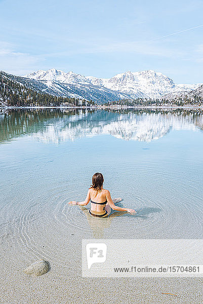 Woman enjoying lake in cold winter  Mammoth Lakes  California  USA