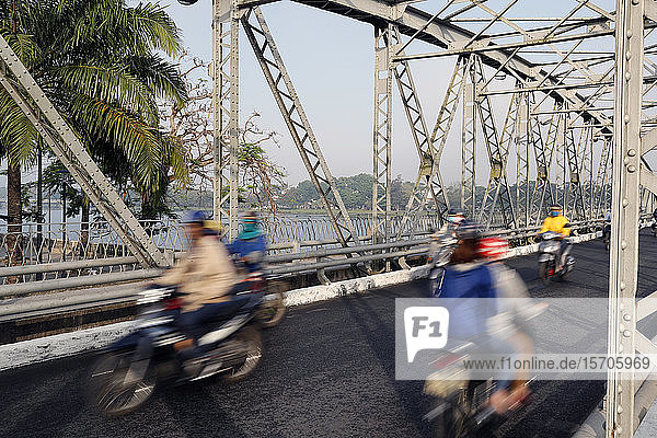 Scooters crossing the famous Trang Tien bridge in morning rush hour traffic  Hue  Vietnam  Indochina  Southeast Asia  Asia