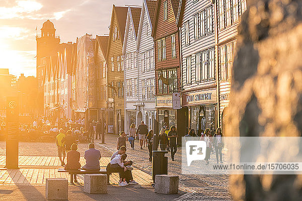 Tourists in Bryggen Old Town at sunset UNESCO World Heritage Site Bergen Hordaland County Norway Scandinavia Europe
