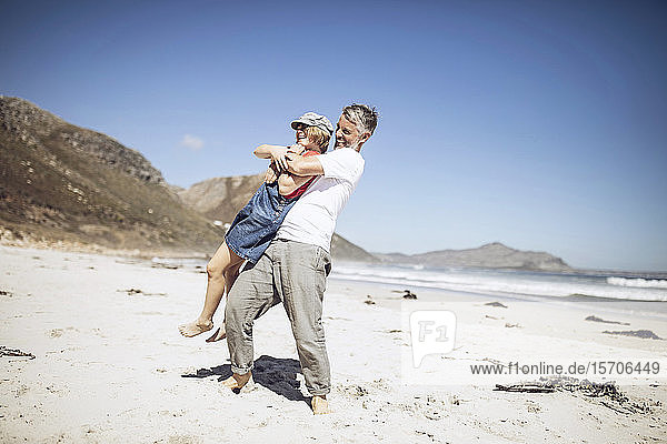 Father and daughter having fun together on the beach  Cape Town  Western Cape  South Africa