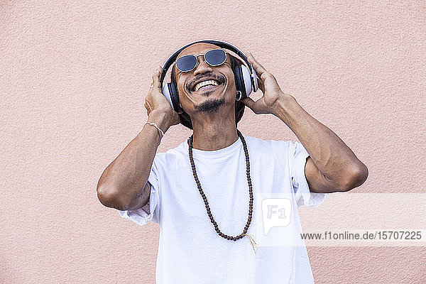 Portrait of mature man with dreadlocks and headphones  listening music