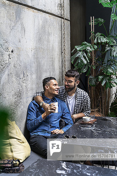 Gay couple sitting at outdoor cafe  Barcelona  Spain