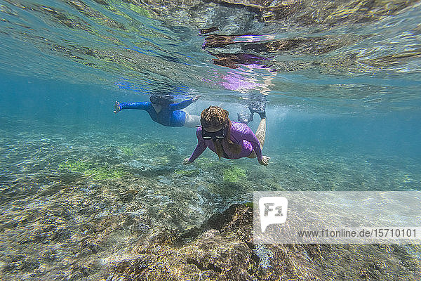 Two young women snorkeling in Nusa Penida island  Bali  Indonesia