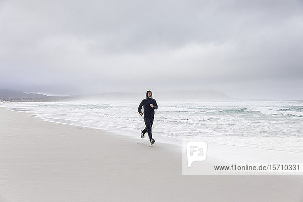 Man jogging on the beach  Nordhoek  Western Cape  South Africa
