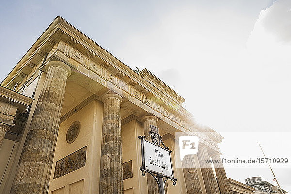 Germany Berlin Low angle view of Brandenburg Gate basked in sunlight