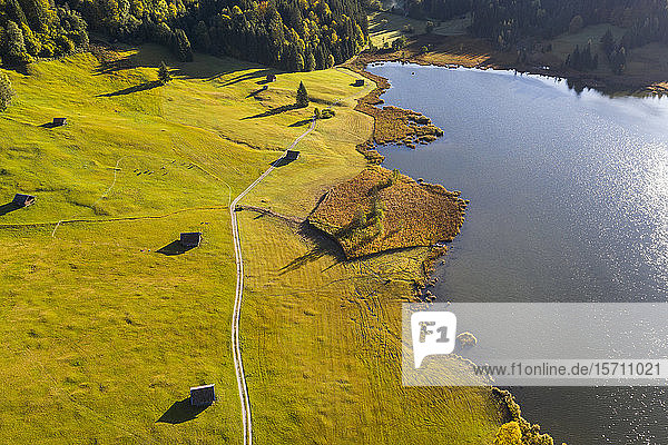Germany  Bavaria  Krun  Aerial view of dirt road stretching along shore of Geroldsee lake