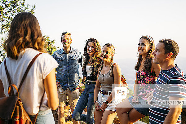 Group of friends looking at woman leading a tour