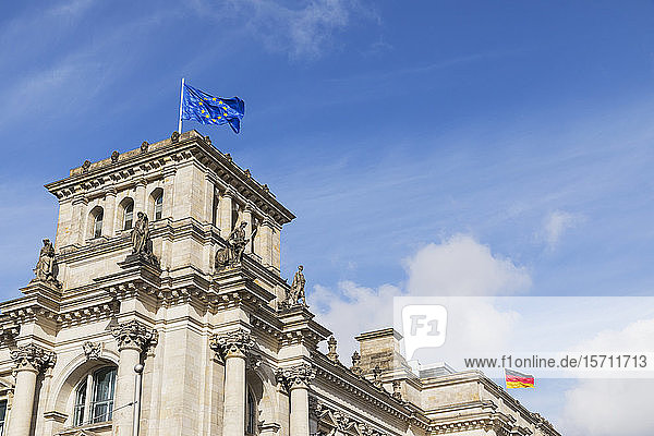 Germany Berlin European Union and German flags on top of Reichstag building
