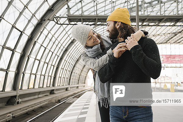 Happy young couple at the station platform  Berlin  Germany