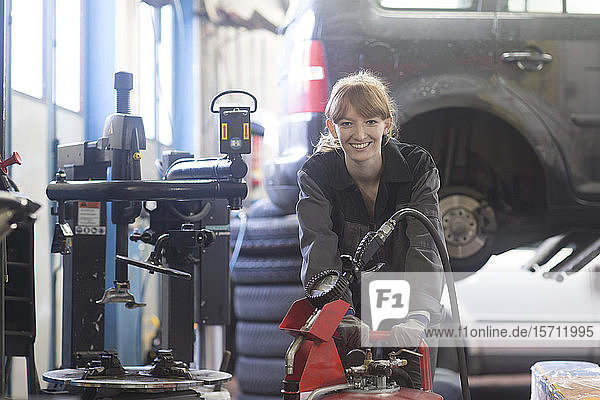 Female car mechanic working in repair garage