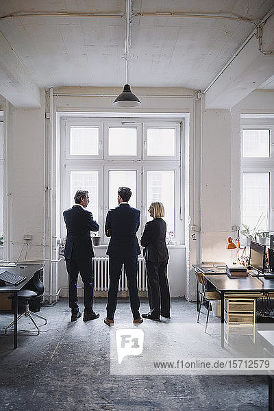 Business people standing at the window in office
