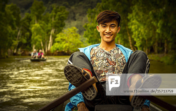 Man in rowing boat Ngo Dong River Ninh Binh Province Ha Long Bay Vietnam Asia