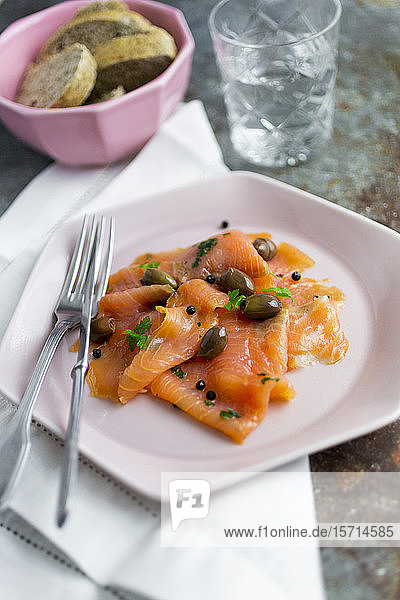 Raw salmon meat with lime  olives and herbs