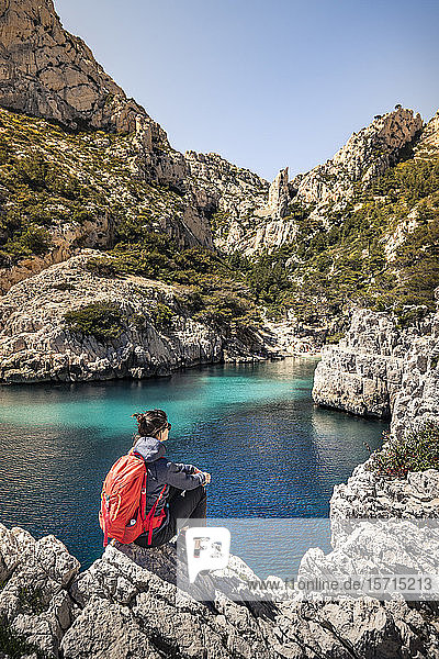 France  Cote d'Azur  Calanques National Park  Woman with backpack  looking at chalk cliffs and bays