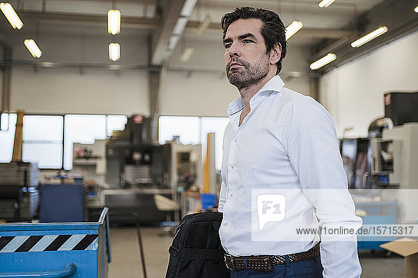 Portrait of a businessman in a factory