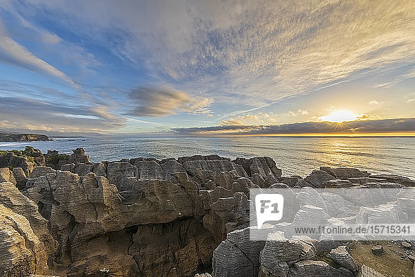 New Zealand  Buller District  Punakaiki  Limestone Pancake Rocks formation and coastal blow hole at sunset
