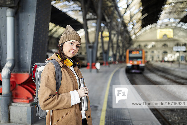 Portrait of smiling young woman at the train station