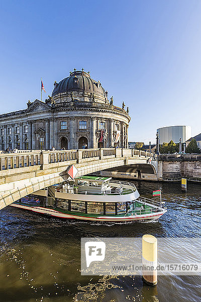 Germany  Berlin  Ferry sailing under bridge in front of Bode Museum