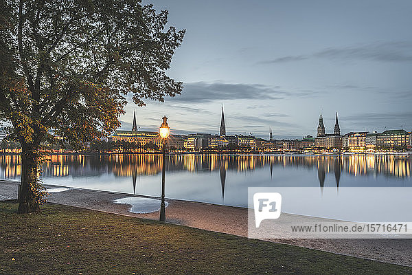 Germany Hamburg Waterfront buildings reflecting in Inner Alster Lake at dawn