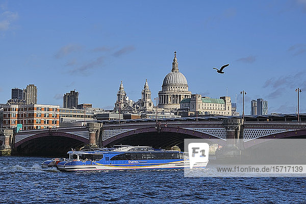 UK  England  London  Tourboat sailing under Blackfriars Bridge with Saint Pauls Cathedral in background