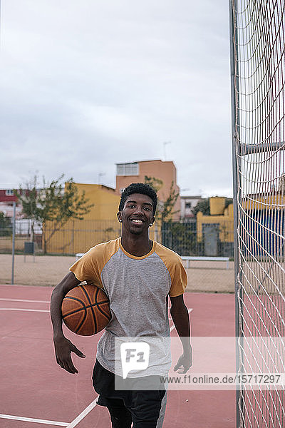Teenager playing basketball