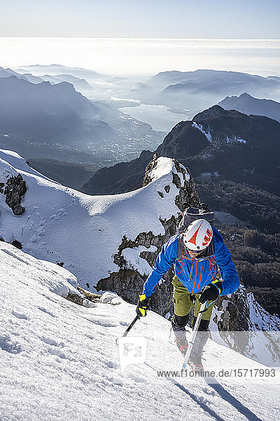 Alpinist ascending a snowy mountain  Orobie Alps  Lecco  Italy