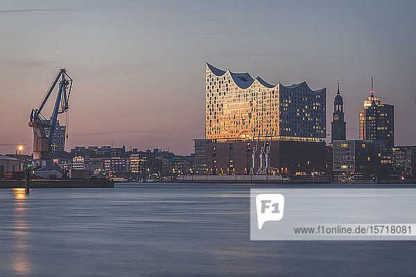 Germany  Hamburg  Industrial crane and Elbphilharmonie at dusk