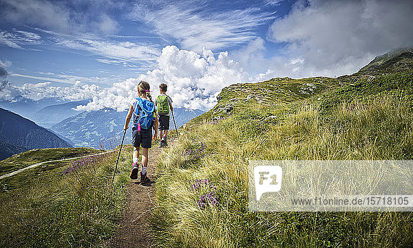 Boy and girl hiking in alpine scenery  Passeier Valley  South Tyrol  Italy