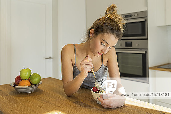 Female teenager during breakfast in the kitchen