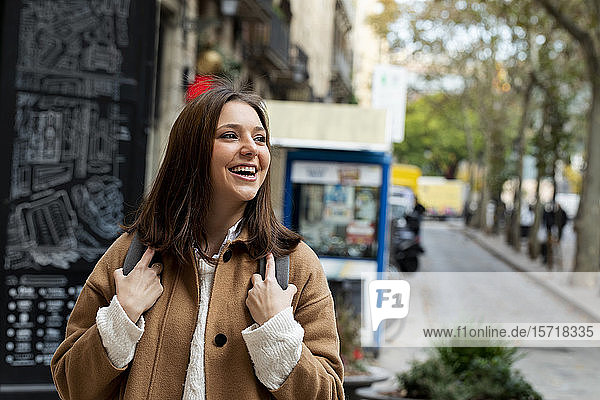 Happy young woman in the city looking around  Barcelona  Spain