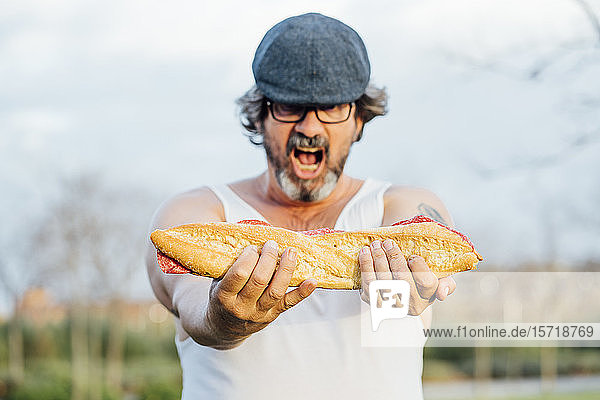 Man holding sandwich and screaming