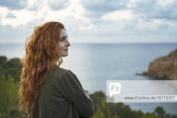 Redheaded young woman at the coast  Ibiza  Spain