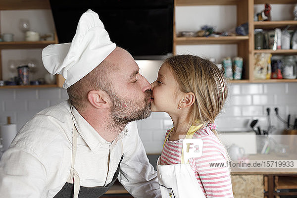 Father and daughter cooking in the kitchen