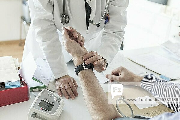 Doctor examine patients pulse.