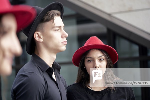 Man and two women wearing hats. Munich  Germany.