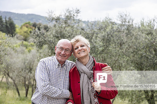 Portrait of senior couple  olive trees in background  Florence  Italy