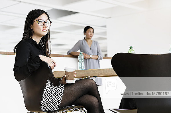 Businesswomen taking coffee break in office