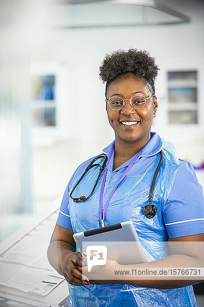 Portrait confident female nurse with digital tablet