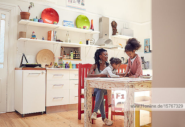 Mother and daughters at kitchen table