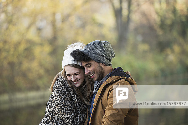 Affectionate young couple hugging outdoors