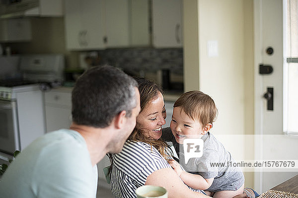Happy young family in kitchen