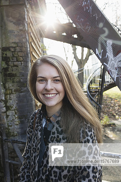 Porträt lächelnde junge Frau im Stadtpark