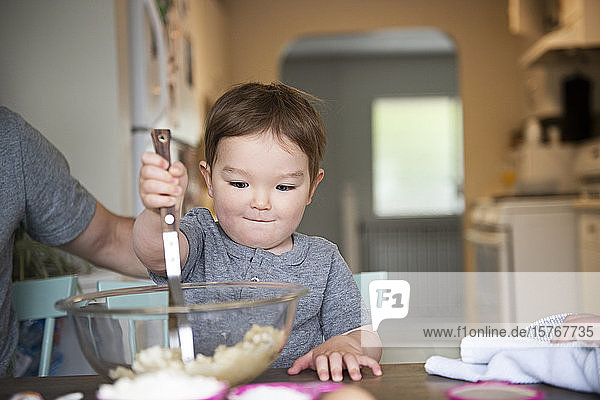 Cute toddler girl baking