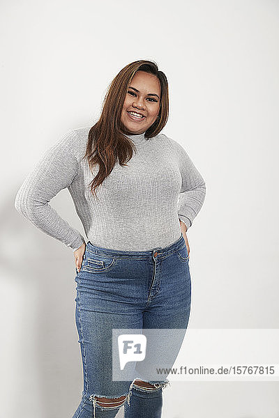 Porträt selbstbewusste junge Frau in Pullover und Jeans