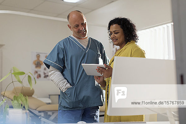 Doctors consulting  using digital tablet in doctors office