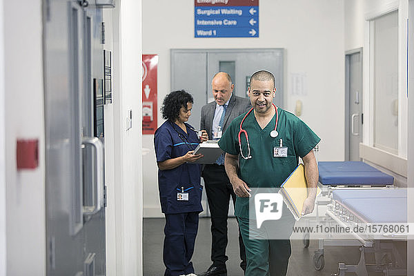 Male surgeon walking in hospital corridor