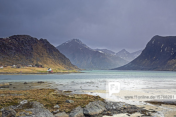 Scenic view mountains and ocean Flakstadpollen Lofoten Norway