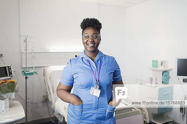 Portrait confident  smiling female nurse in hospital room