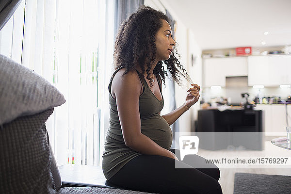 Young pregnant woman in living room