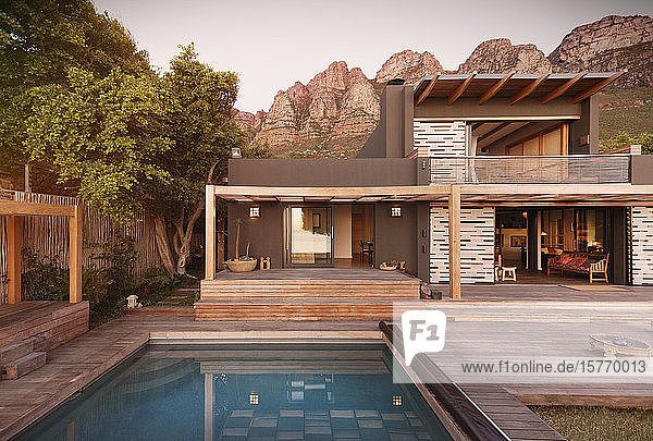 Mountains behind modern luxury home showcase exterior house with swimming pool